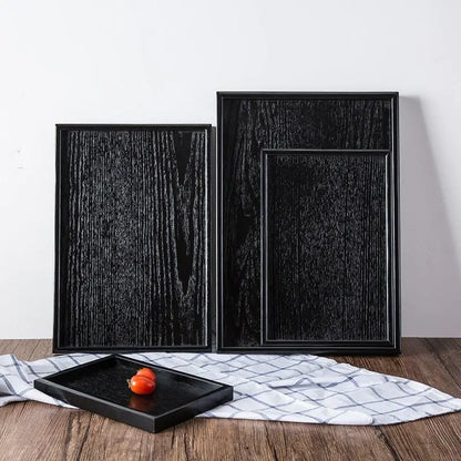 Bandejas de madera negra de estilo japonés.